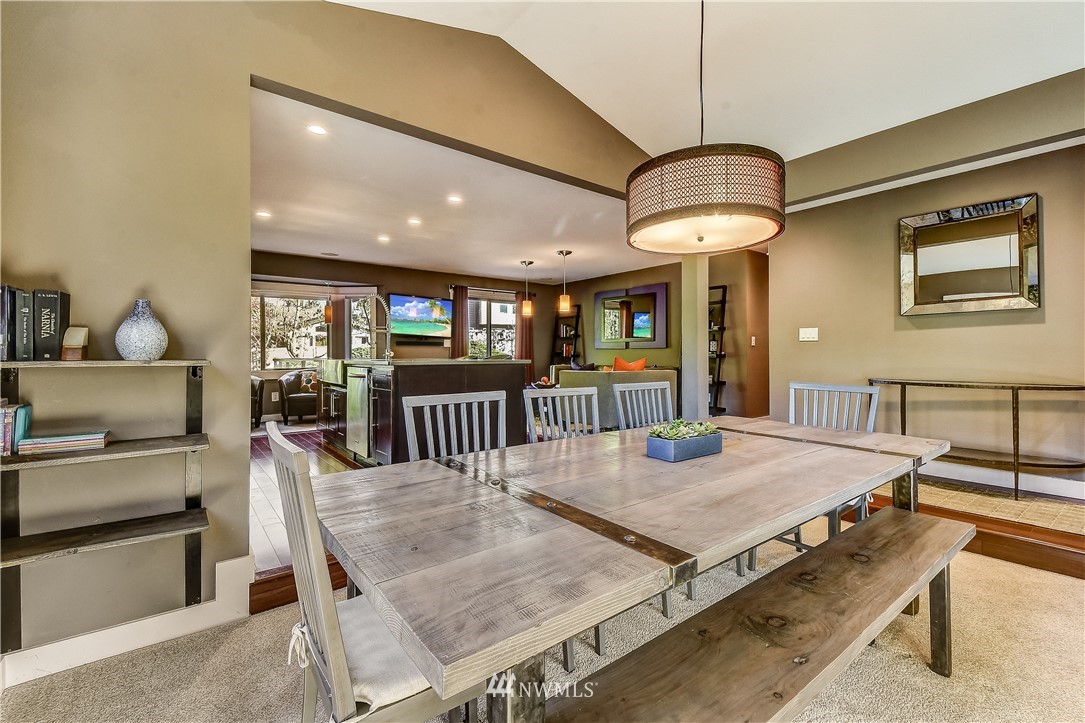 1307 221st Place Southwest Bothell, WA 98021 - Photo 5 of 20 a dining room with wooden floor a chandelier a wooden table and chairs