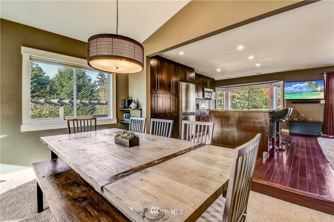 1307 221st Place Southwest Bothell, WA 98021 - Photo 6 of 20 a view of a dining room with furniture window and wooden floor