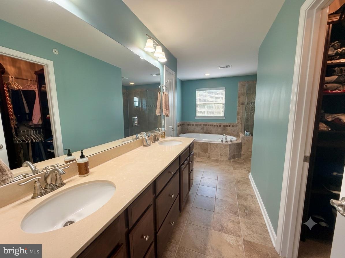 17875 Sugarberry Road Dumfries, VA 22026 - Photo 13 of 30 a bathroom with a sink double vanity granite and a mirror