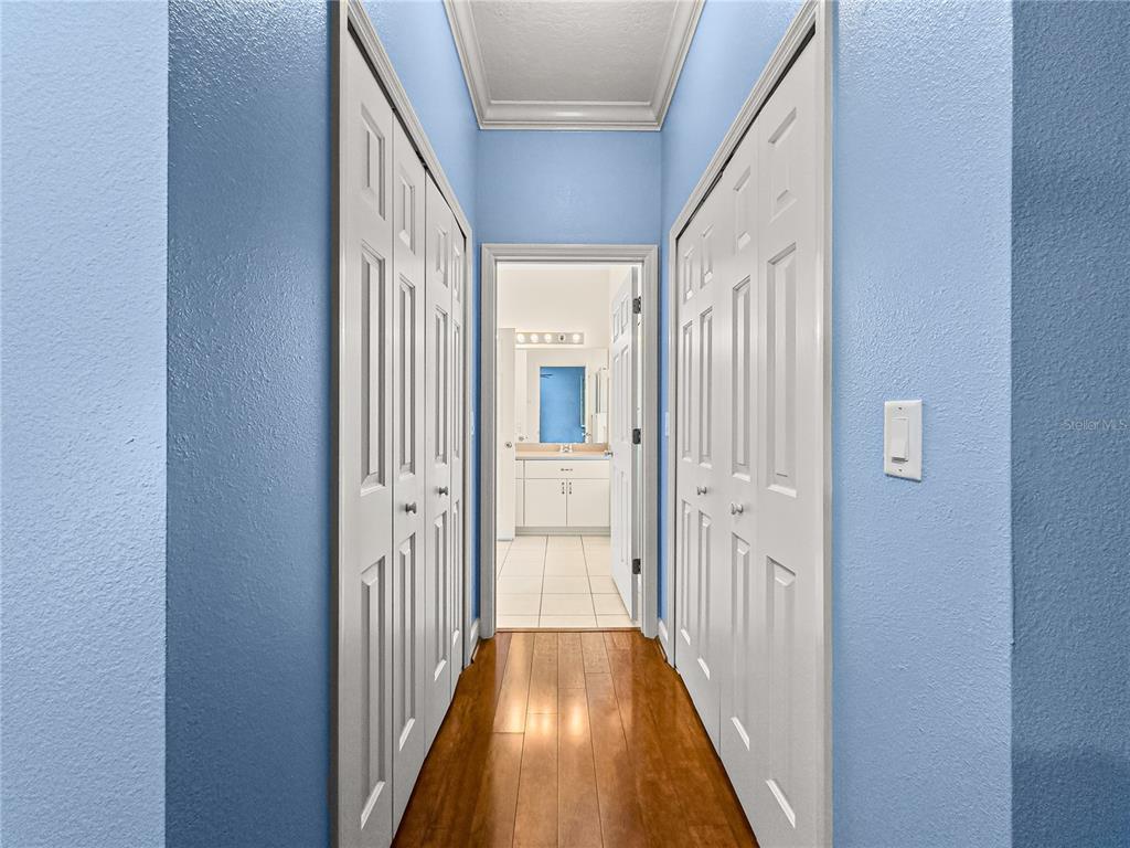 8045 Waterbury Way Mount Dora, FL 32757 - Photo 23 of 56 a view of a hallway with wooden floor and staircase