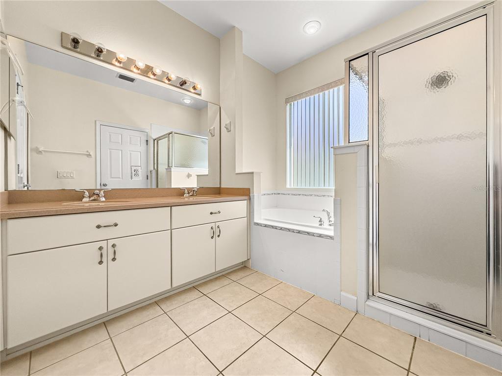 8045 Waterbury Way Mount Dora, FL 32757 - Photo 26 of 56 a spacious bathroom with a double vanity sink mirror and shower