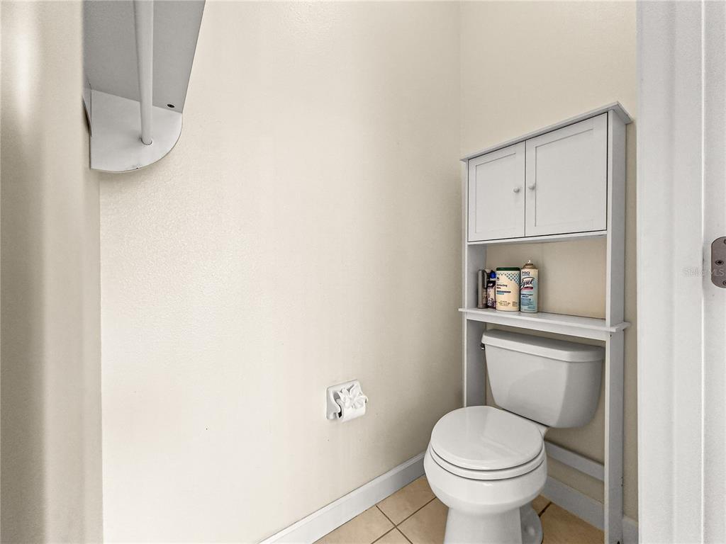8045 Waterbury Way Mount Dora, FL 32757 - Photo 27 of 56 a white toilet sitting next to a bathroom sink