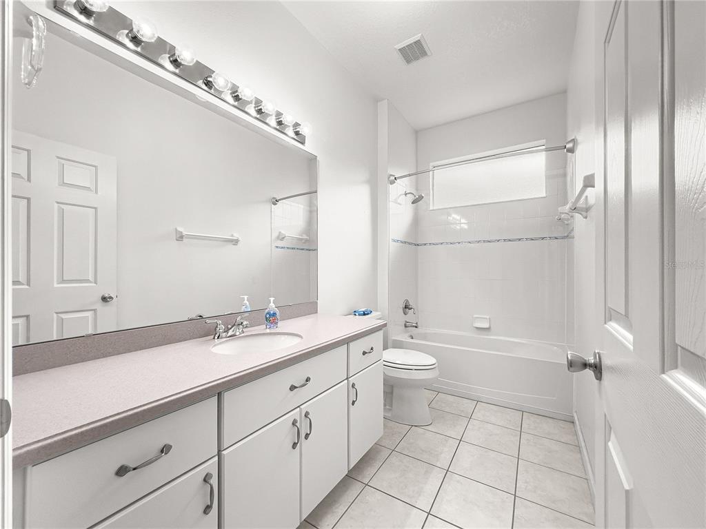 8045 Waterbury Way Mount Dora, FL 32757 - Photo 30 of 56 a spacious bathroom with a double vanity sink a mirror and a bathtub