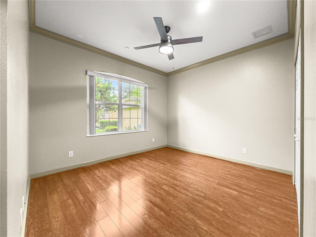 8045 Waterbury Way Mount Dora, FL 32757 - Photo 31 of 56 an empty room with window and ceiling fan