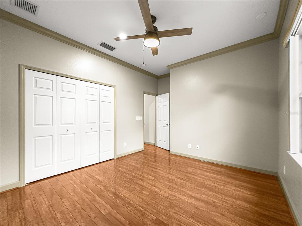 8045 Waterbury Way Mount Dora, FL 32757 - Photo 32 of 56 wooden floor in an empty room with a window
