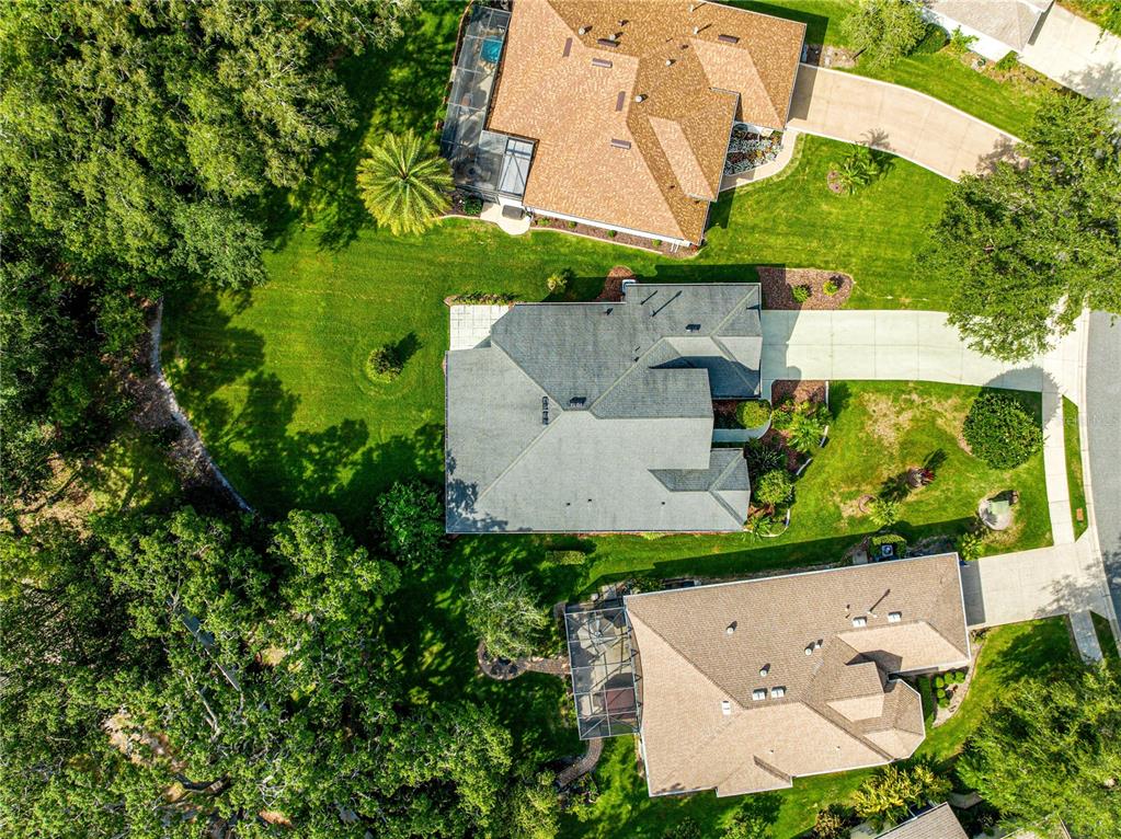 8045 Waterbury Way Mount Dora, FL 32757 - Photo 45 of 56 an aerial view of a house with a yard and outdoor seating