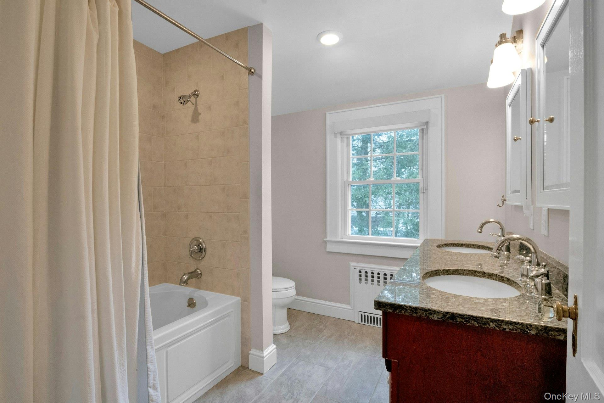 25 Maple Road Briarcliff Manor, NY 10510 - Photo 35 of 48 Updated Hall Bathroom with granite double sink vanity & a Whirlpool Tub/Shower.