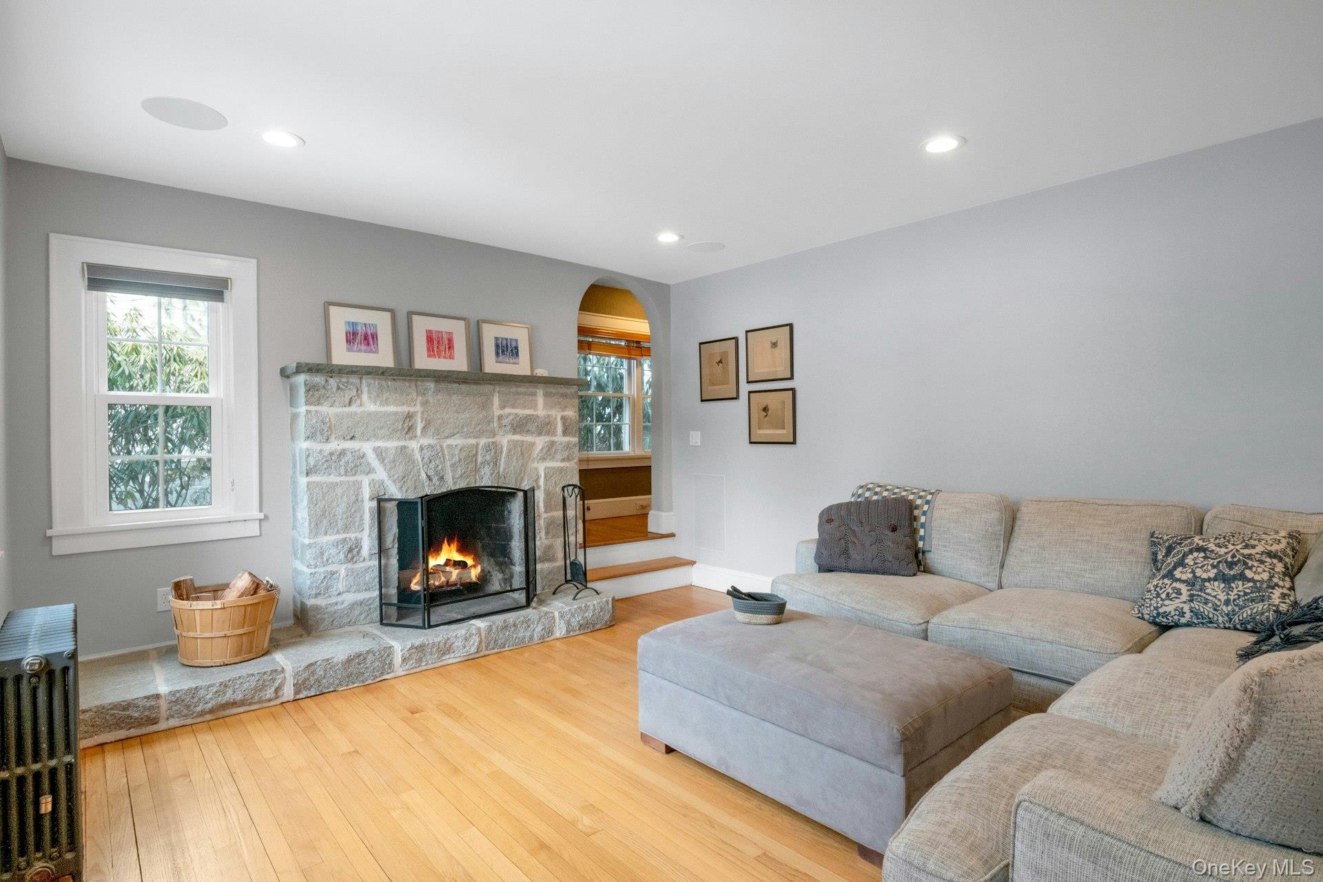 25 Maple Road Briarcliff Manor, NY 10510 - Photo 6 of 48 A closer look at the stone FPL in the Living Room, and the arched opening to the landing for the stairs to the second floor.