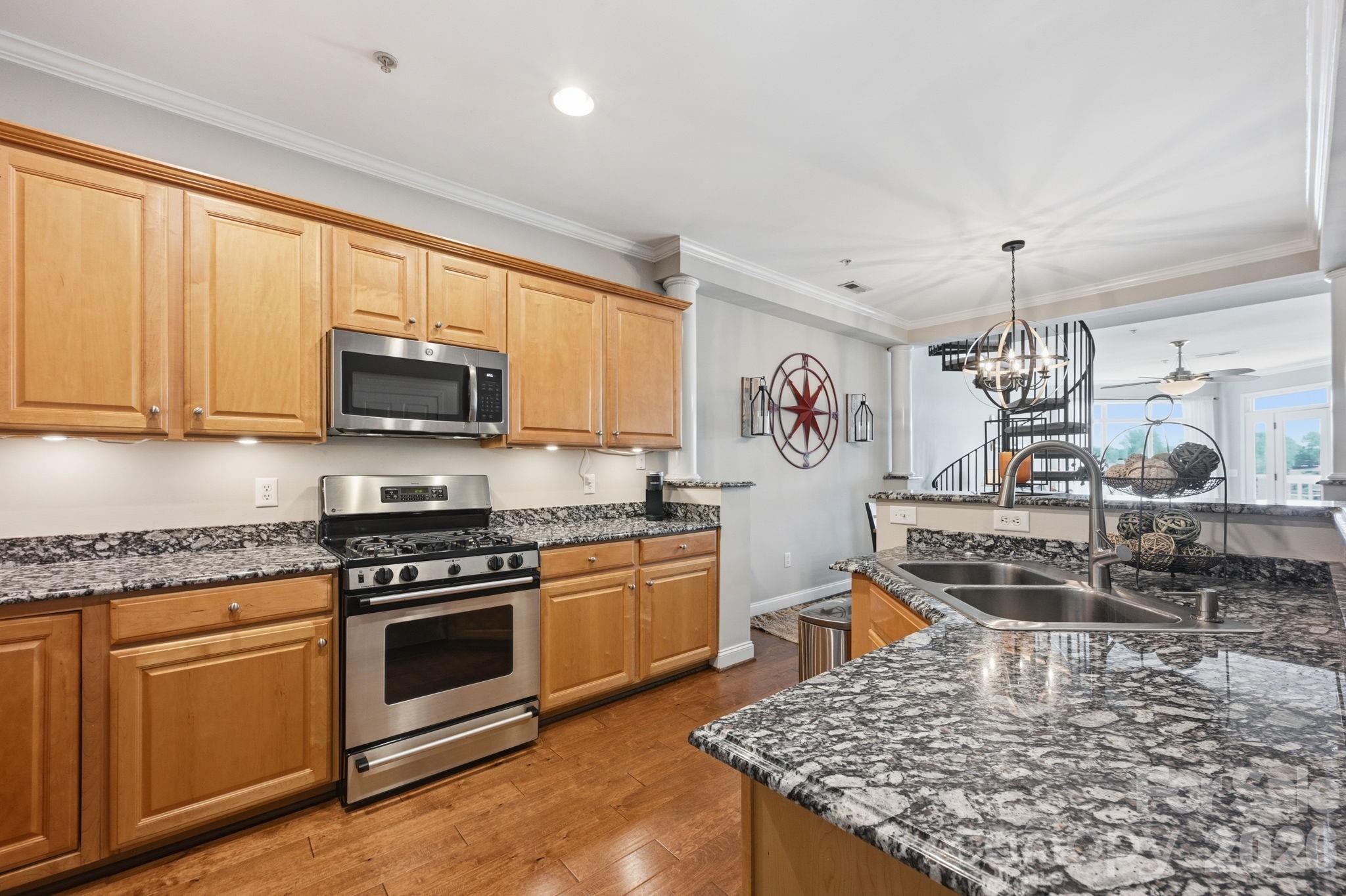637 Williamson Road, Unit 307 Mooresville, NC 28117 - Photo 12 of 44 a kitchen with stainless steel appliances granite countertop a stove oven and a white cabinets