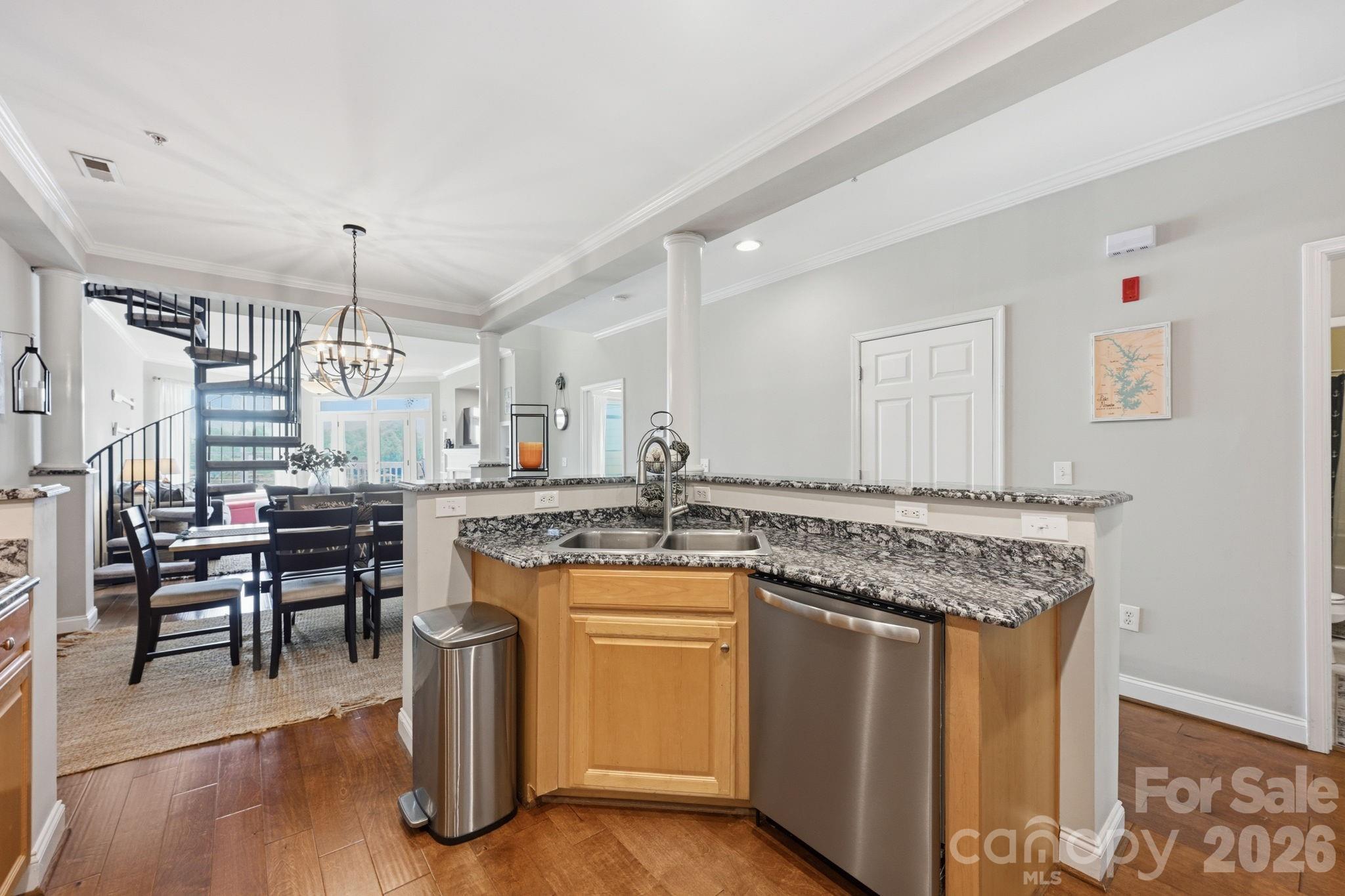 637 Williamson Road, Unit 307 Mooresville, NC 28117 - Photo 14 of 44 a kitchen with kitchen island granite countertop a table chairs stove a sink and dishwasher