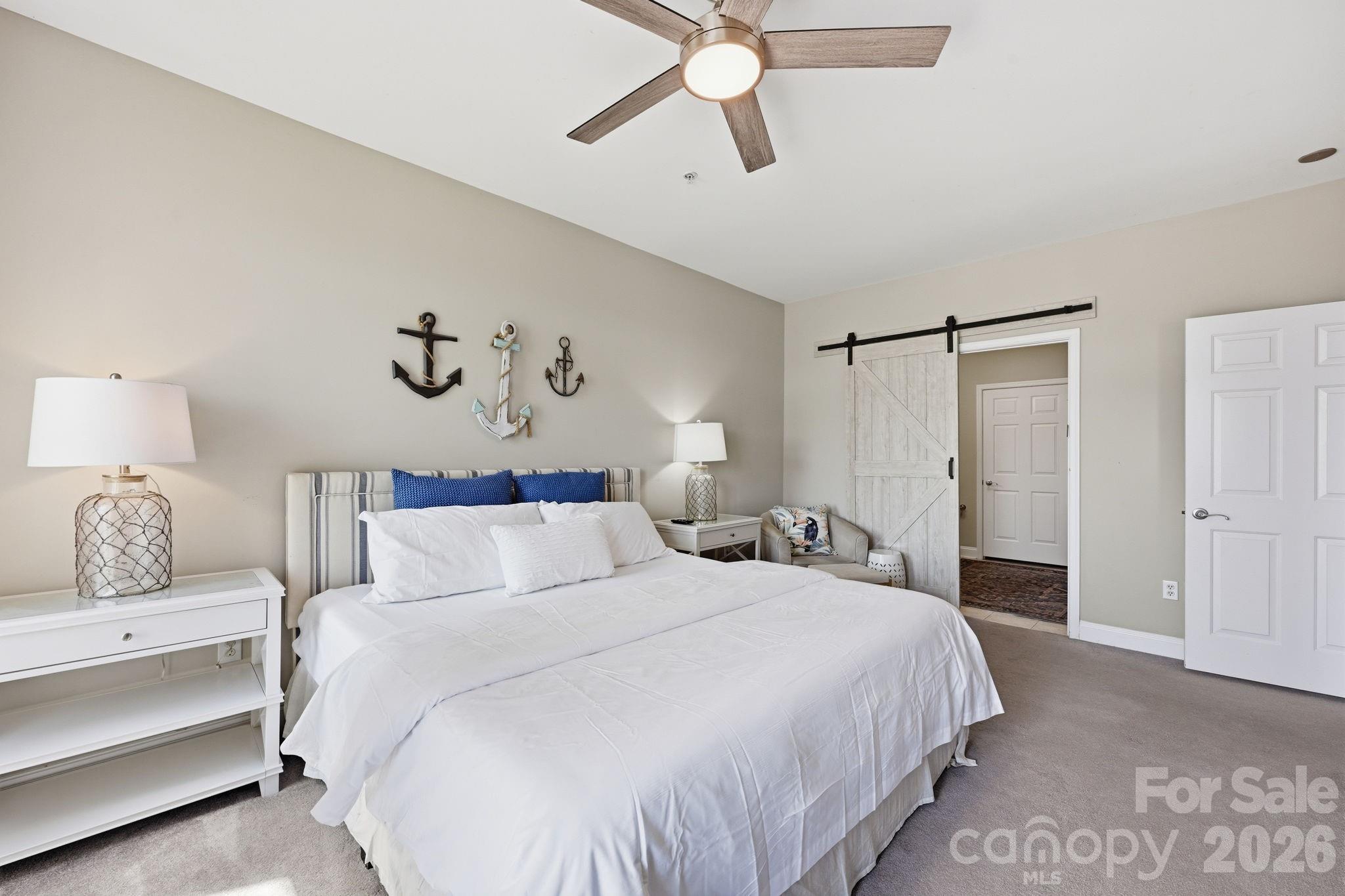 637 Williamson Road, Unit 307 Mooresville, NC 28117 - Photo 15 of 44 a bedroom with a bed and a painting on the wall