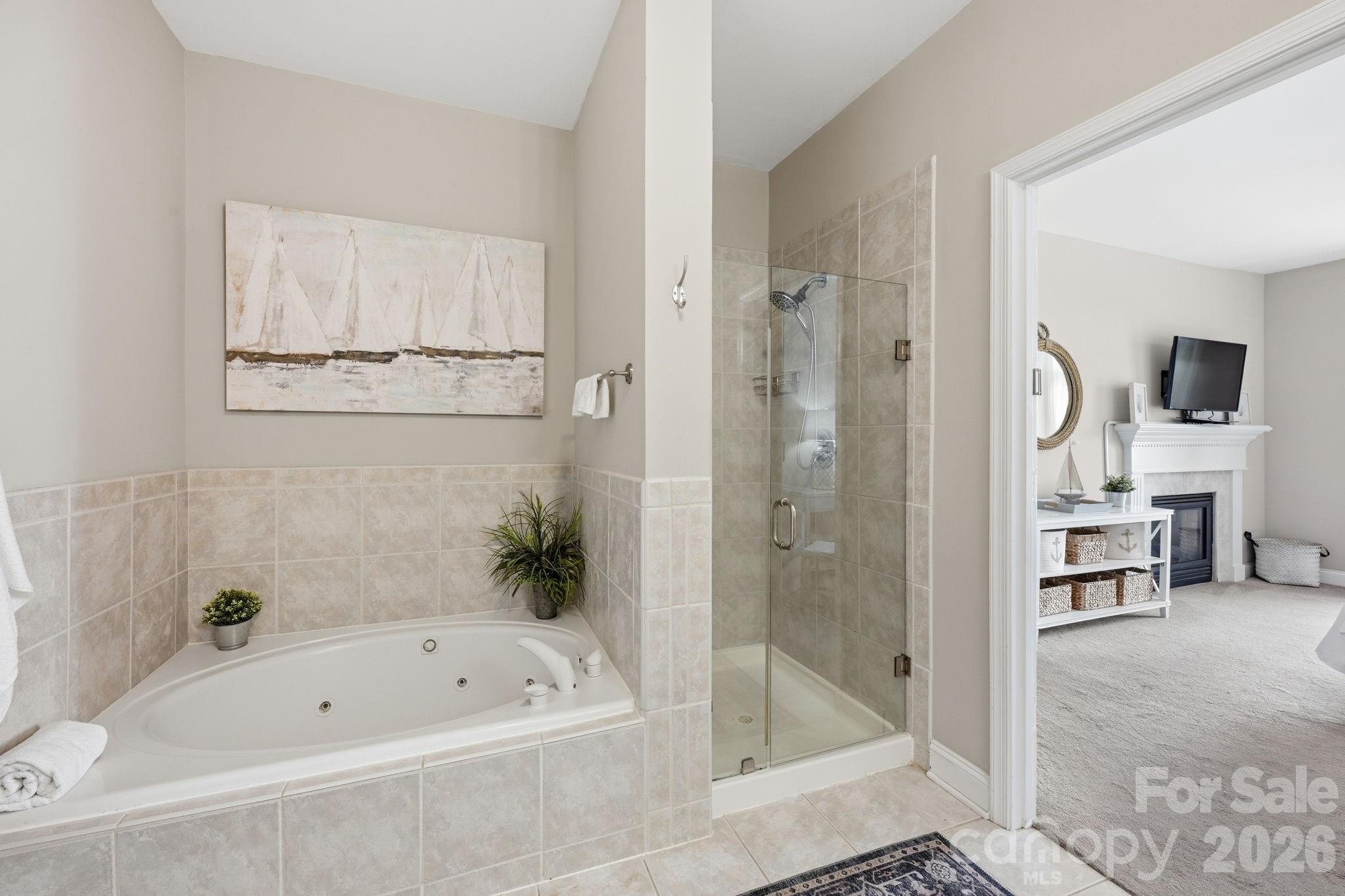 637 Williamson Road, Unit 307 Mooresville, NC 28117 - Photo 18 of 44 a bathroom with a tub a sink and a shower