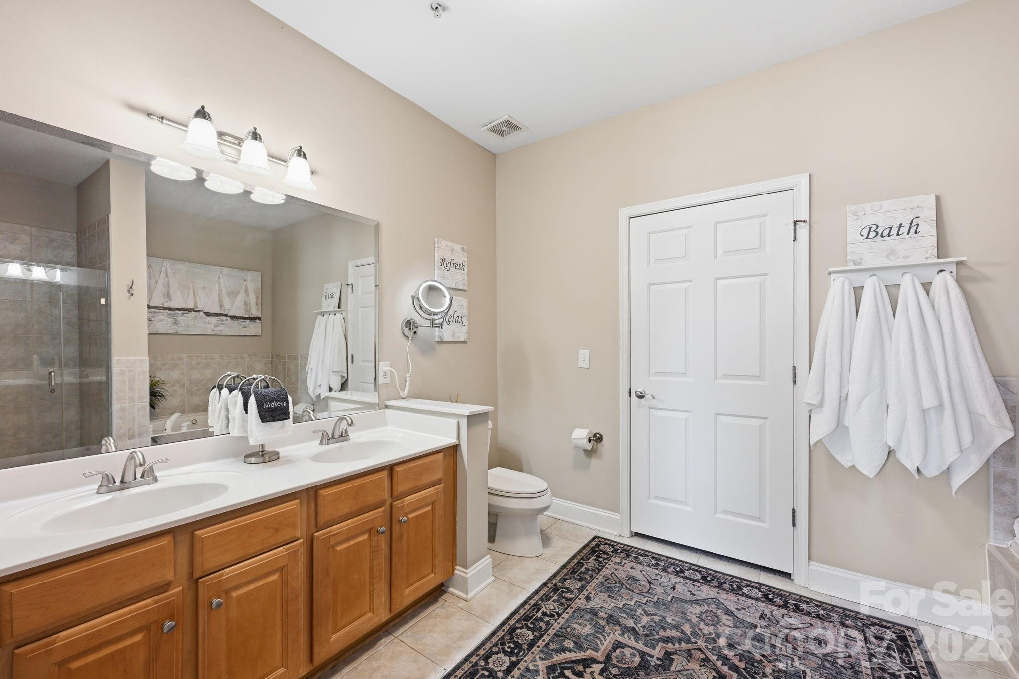 637 Williamson Road, Unit 307 Mooresville, NC 28117 - Photo 19 of 44 a spacious bathroom with a double vanity sink mirror and toilet