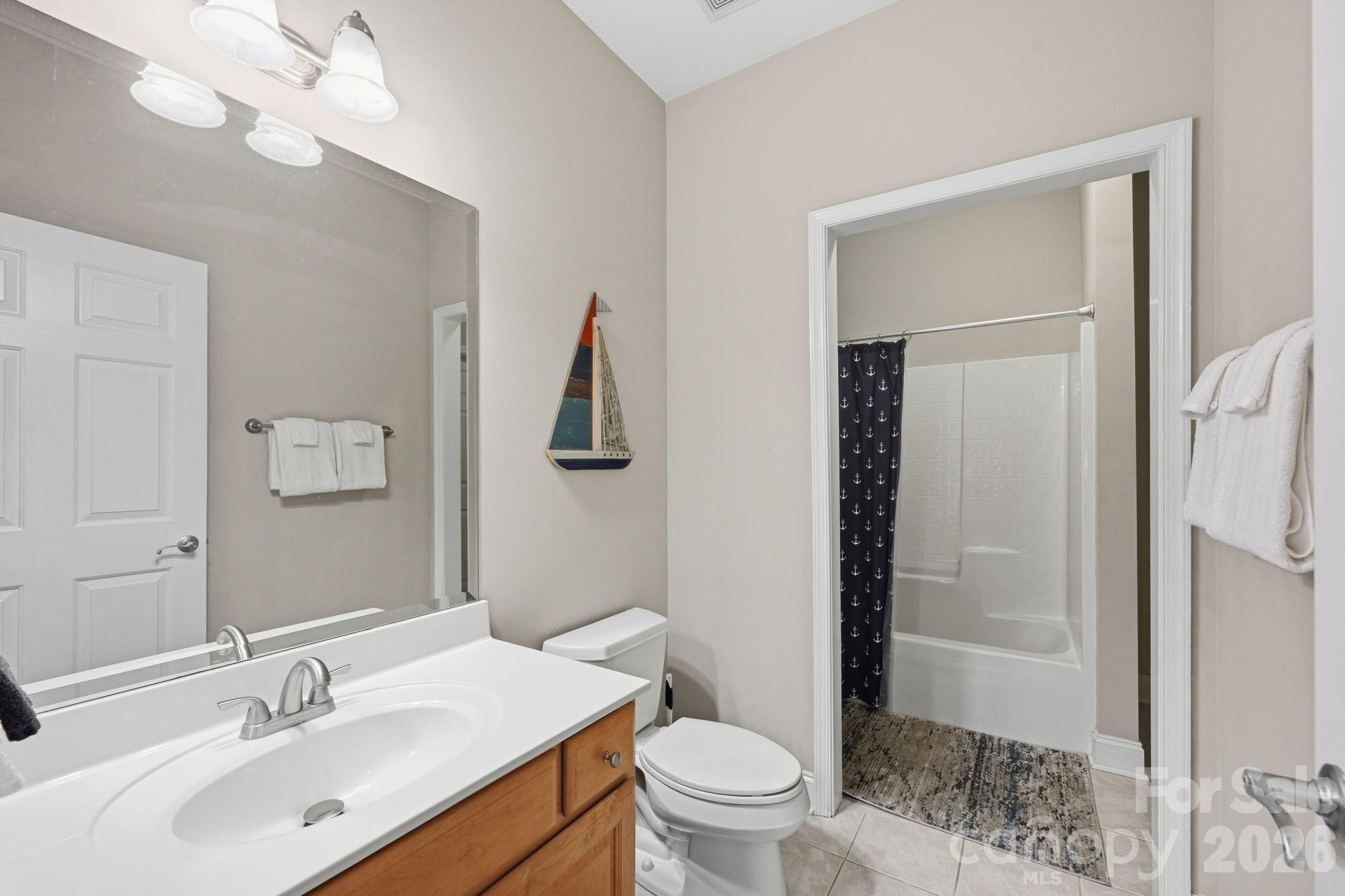 637 Williamson Road, Unit 307 Mooresville, NC 28117 - Photo 23 of 44 a bathroom with a sink vanity granite toilet and shower