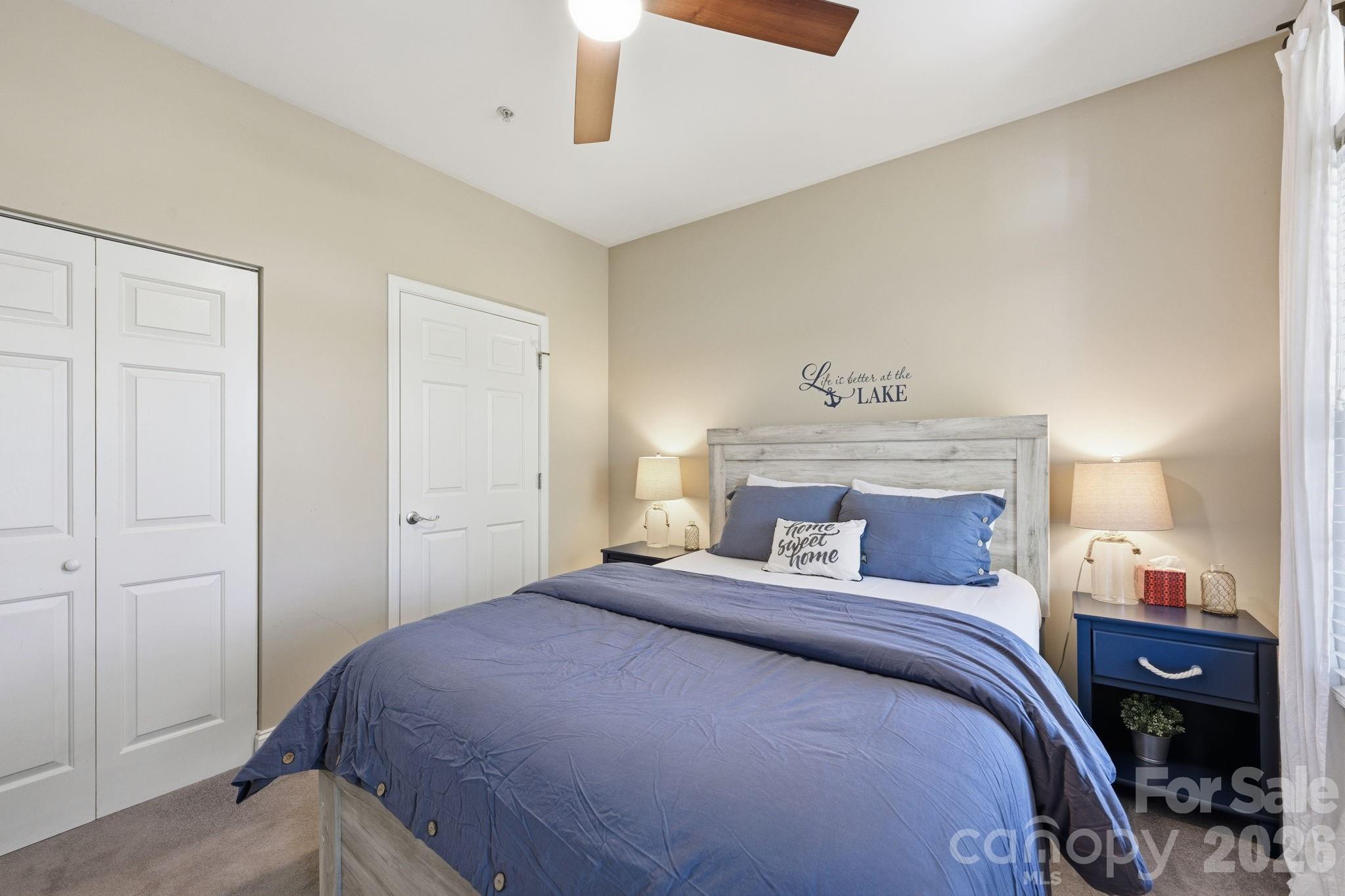 637 Williamson Road, Unit 307 Mooresville, NC 28117 - Photo 25 of 44 a bedroom with a bed and a night stand