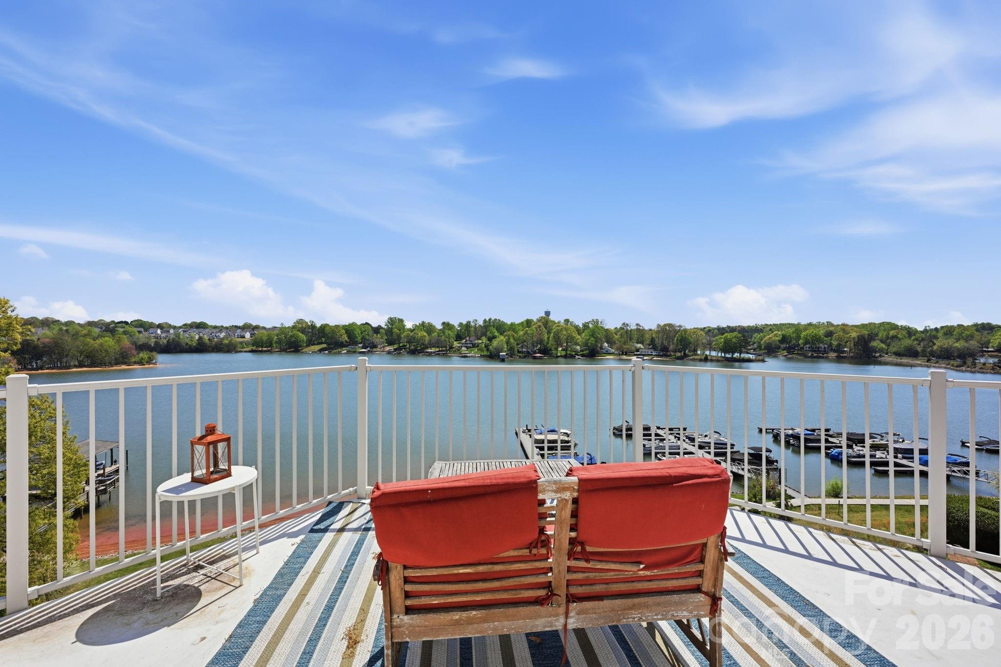 637 Williamson Road, Unit 307 Mooresville, NC 28117 - Photo 28 of 44 a view of a deck with two chair and wooden floor