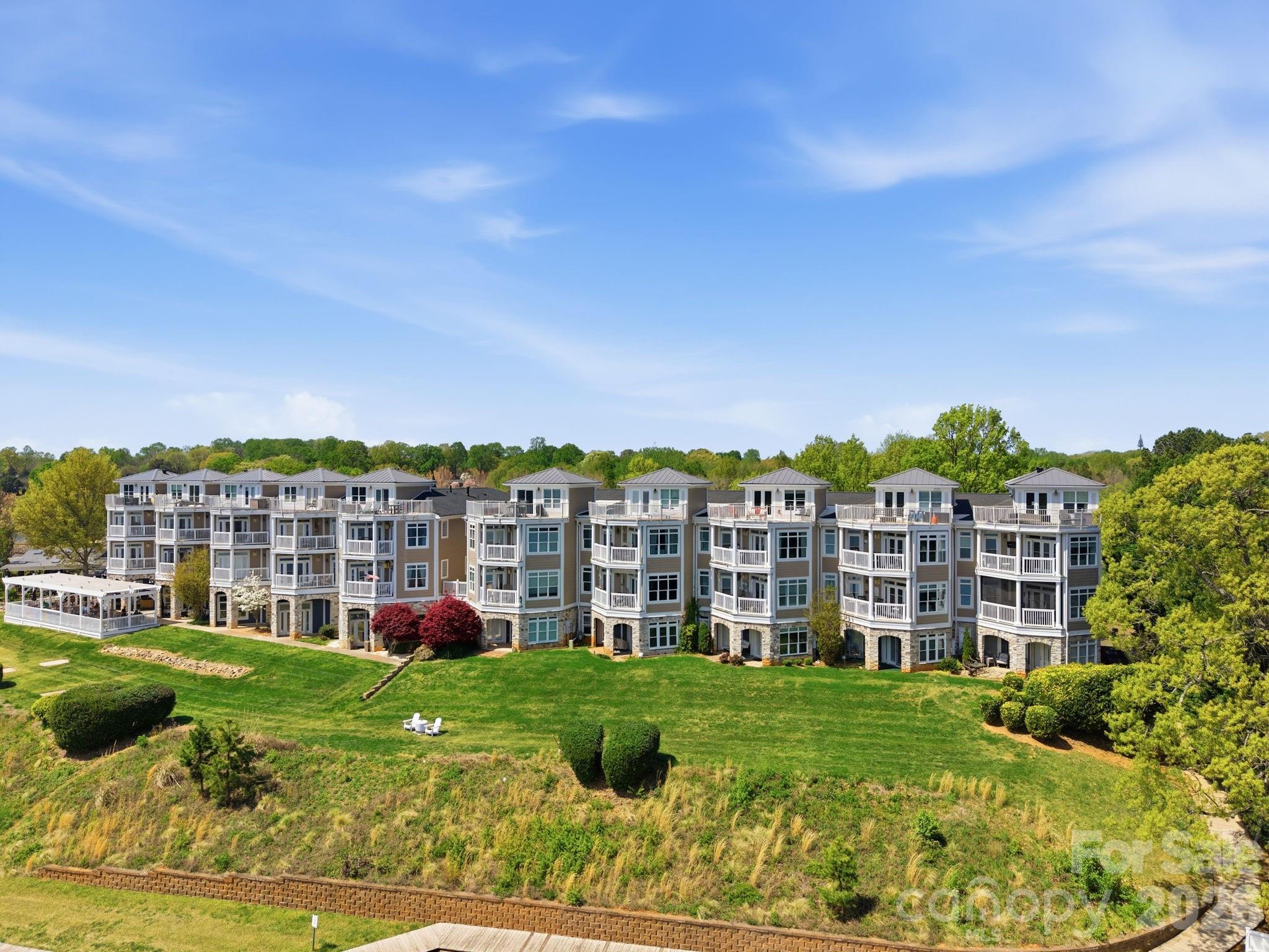 637 Williamson Road, Unit 307 Mooresville, NC 28117 - Photo 35 of 44 a view of a big building with a big yard and plants