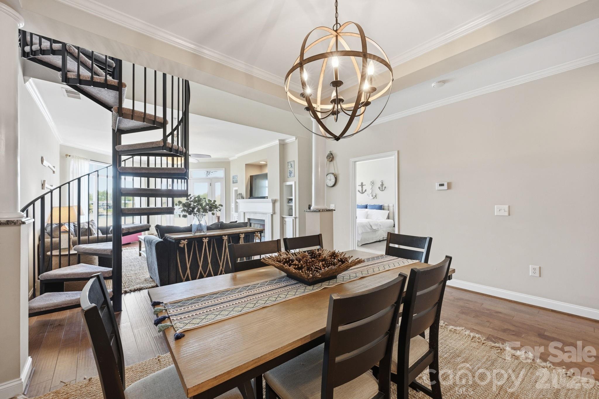 637 Williamson Road, Unit 307 Mooresville, NC 28117 - Photo 9 of 44 a view of a dining room with furniture wooden floor and chandelier
