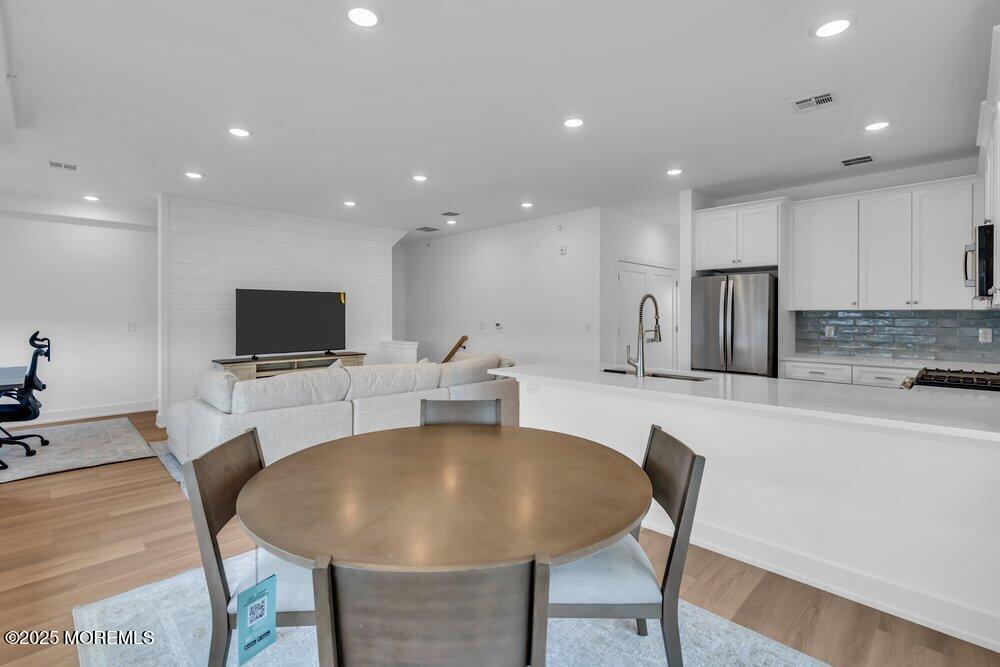 629-631 Highway 88, Unit 13 Point Pleasant, NJ 08742 - Photo 14 of 28 a living room with furniture a flat screen tv and kitchen view