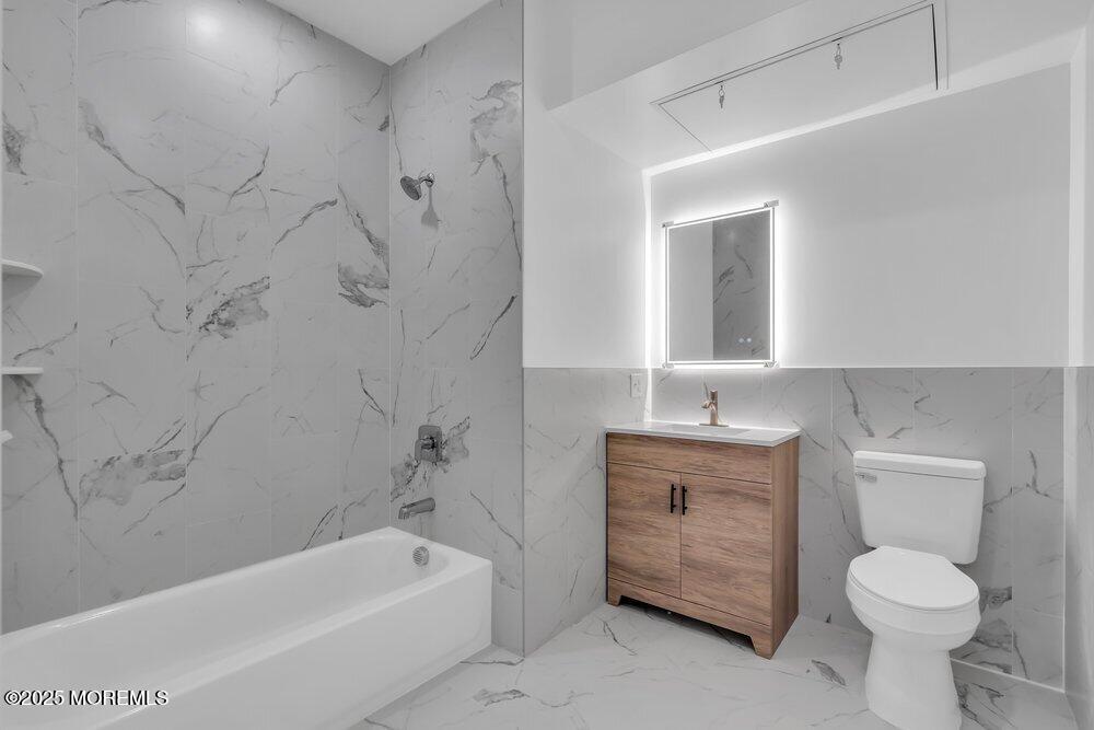 629-631 Highway 88, Unit 13 Point Pleasant, NJ 08742 - Photo 16 of 28 a bathroom with a sink a toilet and bathtub