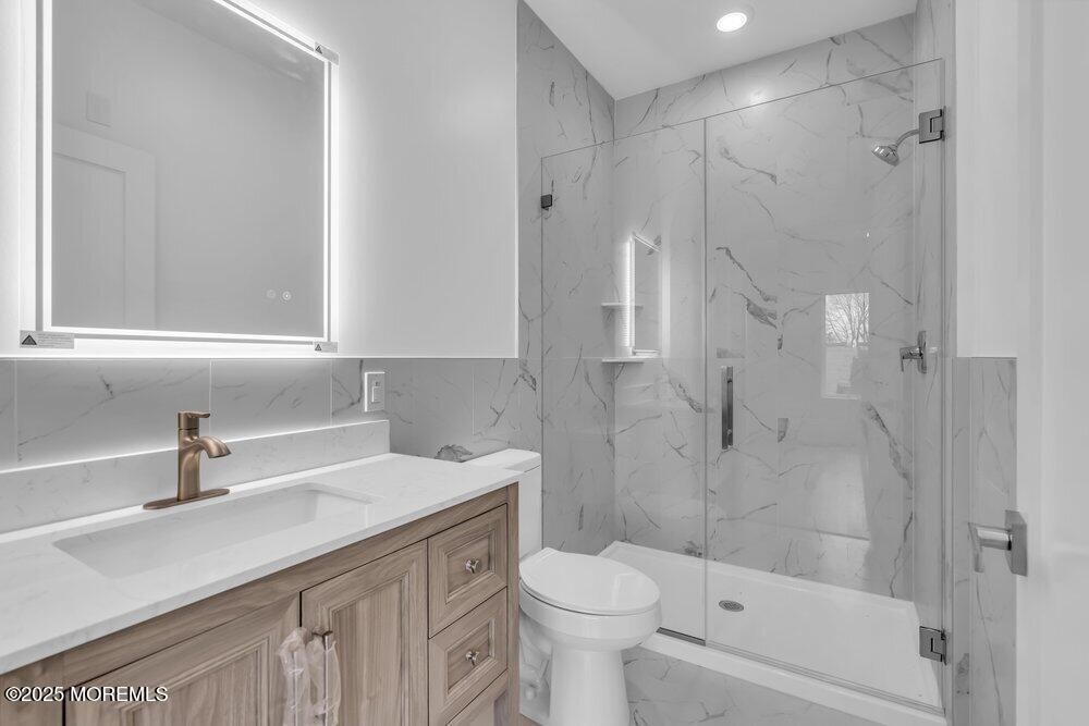 629-631 Highway 88, Unit 13 Point Pleasant, NJ 08742 - Photo 24 of 28 a bathroom with a sink toilet and shower