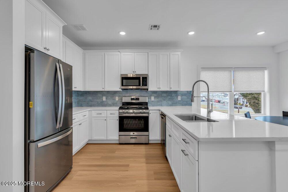 629-631 Highway 88, Unit 13 Point Pleasant, NJ 08742 - Photo 10 of 28 a kitchen with stainless steel appliances granite countertop a refrigerator sink and stove
