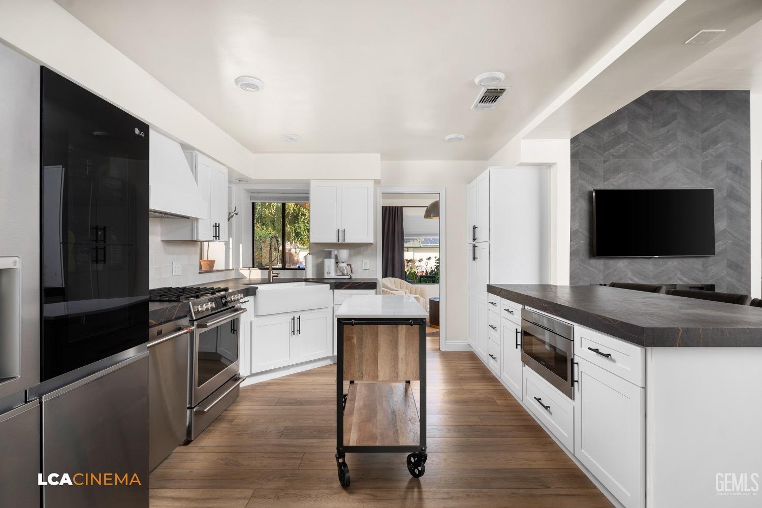 Undisclosed Address Bakersfield, CA 93312 - Photo 12 of 28 a large kitchen with stainless steel appliances granite countertop a stove top oven a sink dishwasher and a refrigerator