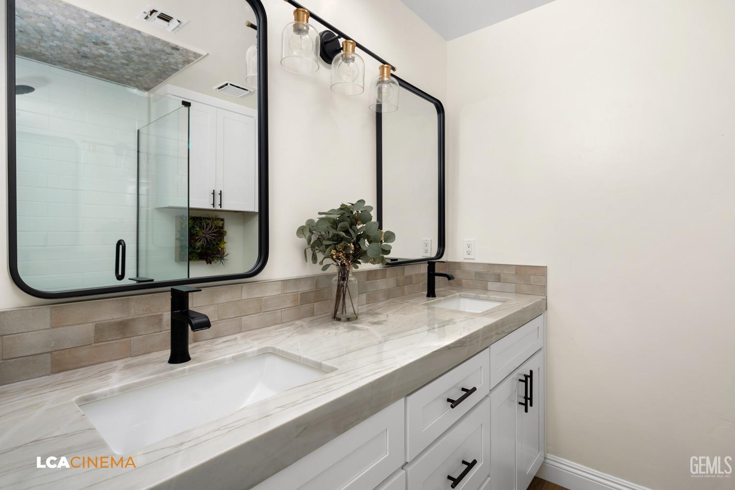 Undisclosed Address Bakersfield, CA 93312 - Photo 15 of 28 a bathroom with a sink and a mirror