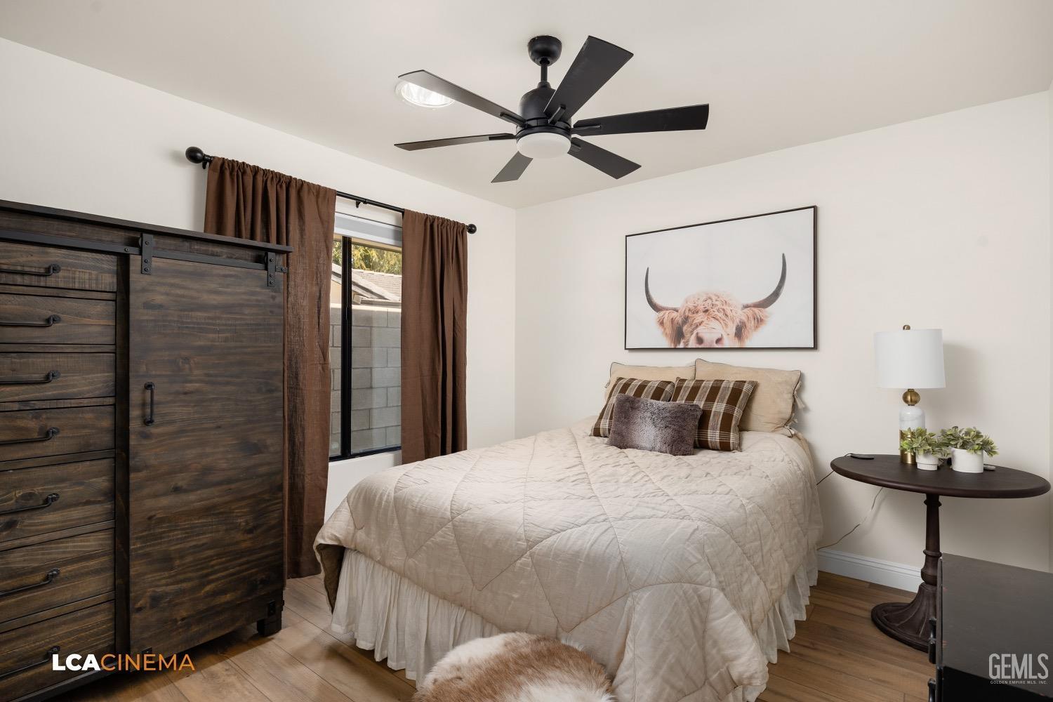 Undisclosed Address Bakersfield, CA 93312 - Photo 17 of 28 a bedroom with a bed and a chandelier