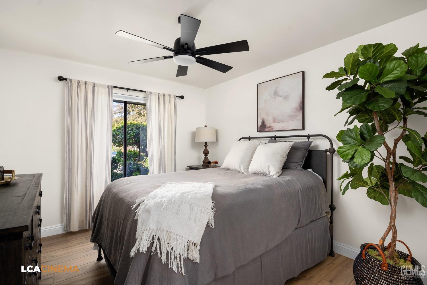 Undisclosed Address Bakersfield, CA 93312 - Photo 18 of 28 a bedroom with a bed and a potted plant