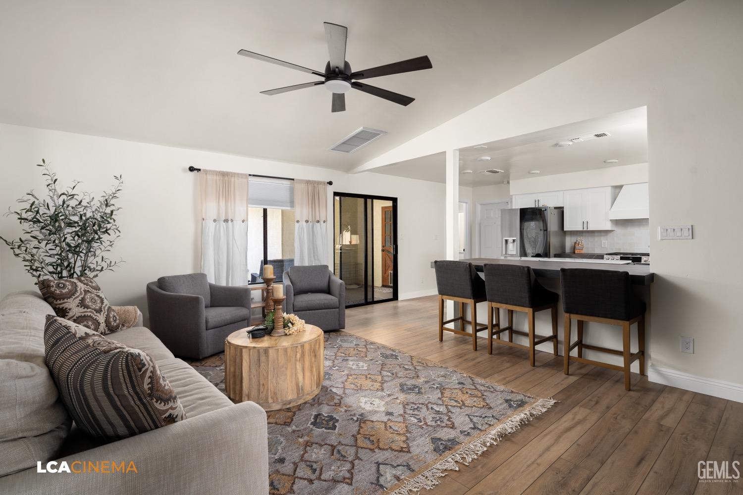 Undisclosed Address Bakersfield, CA 93312 - Photo 2 of 28 a living room with furniture and a dining table with wooden floor