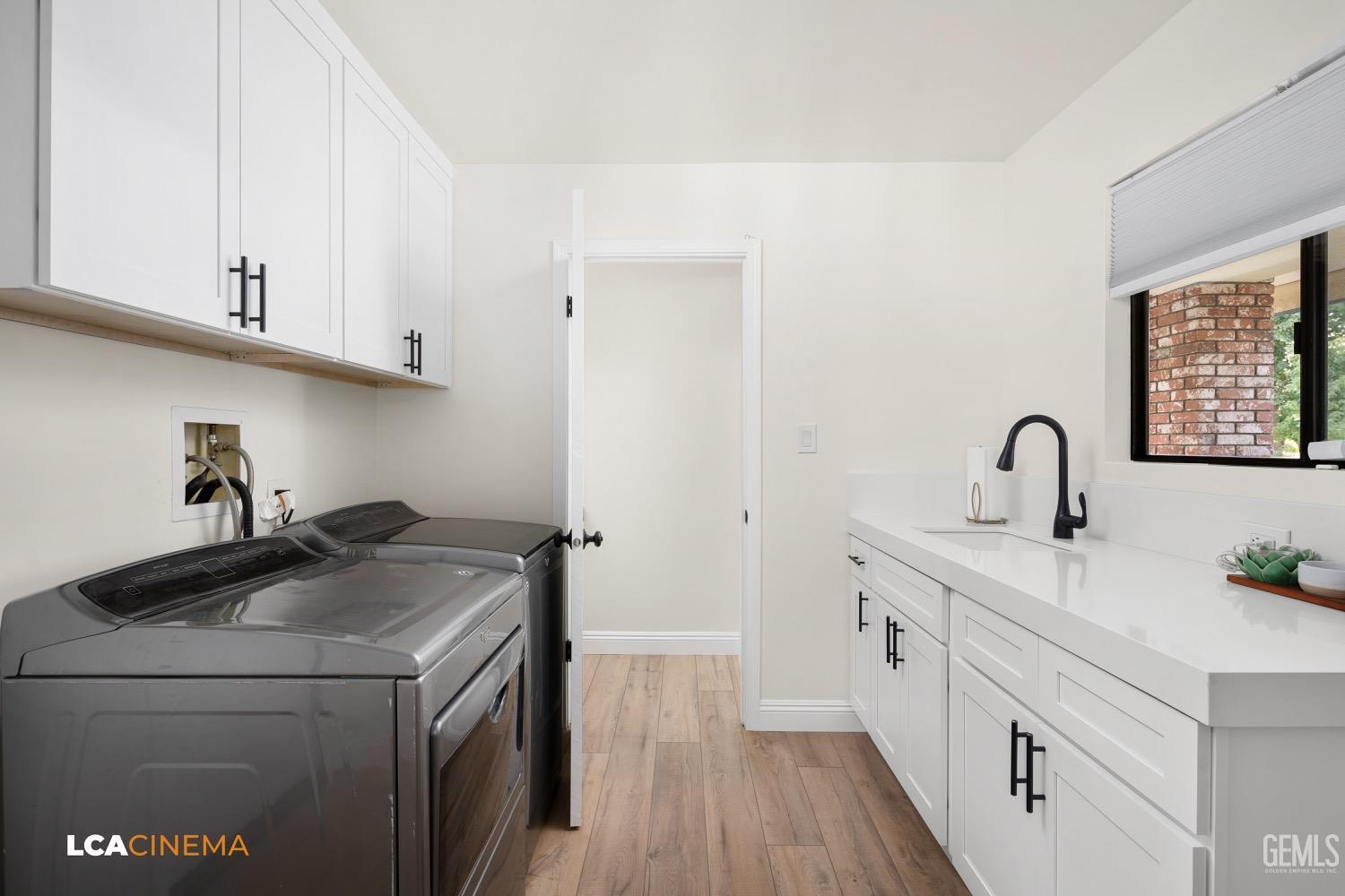 Undisclosed Address Bakersfield, CA 93312 - Photo 21 of 28 a utility room with sink dryer and washer