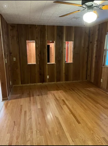 a view of a room with wooden floor and stairs