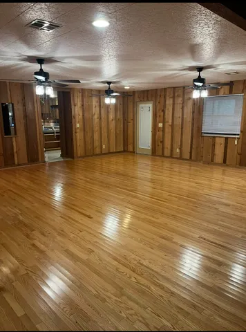 a view of a room with a wooden floor