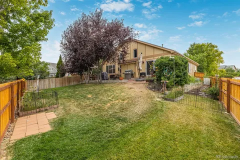 a backyard of a house with table and chairs