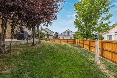 a view of a yard with large trees and a park
