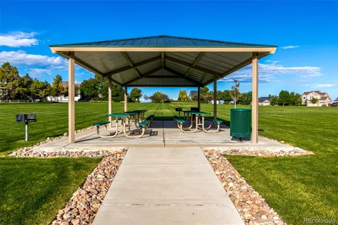 a view of a backyard with table and chairs under an umbrella
