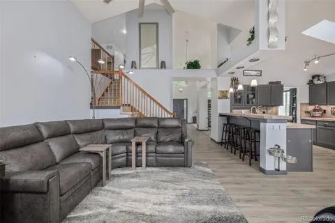 a living room with furniture and kitchen view