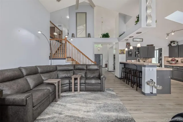 a living room with furniture and kitchen view