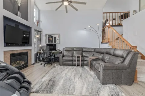 a living room with furniture fireplace and flat screen tv