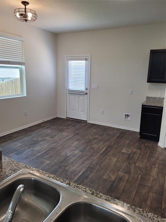 14917 Gypsum Mill Road Manor, TX 78653 - Photo 7 of 28 A well-lit kitchen space features granite counters and robust wood flooring.
