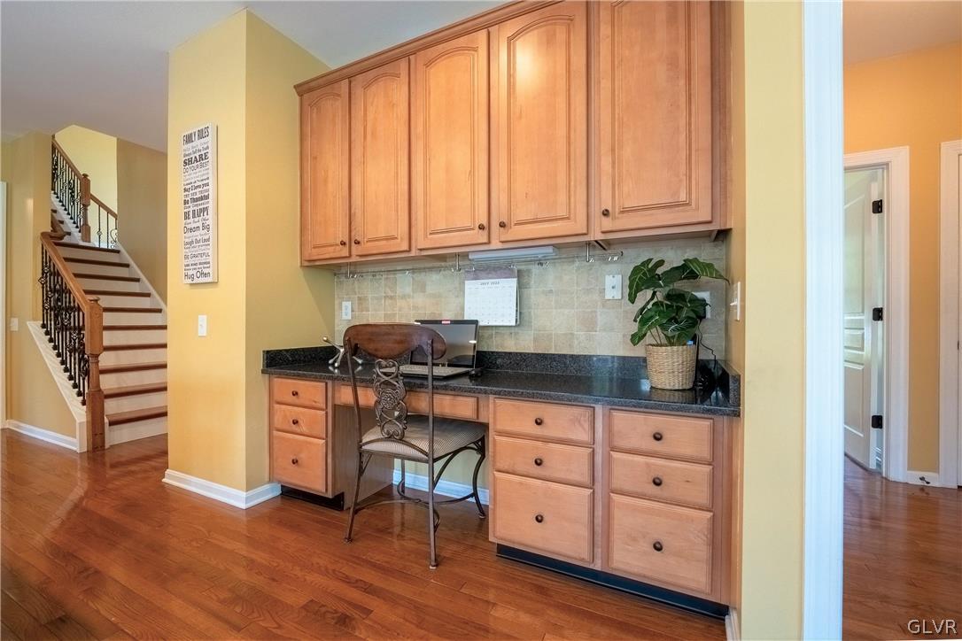 2296 Eldemere Circle Lower Macungie Township, PA 18062 - Photo 13 of 50 a kitchen with granite countertop a stove a sink and dishwasher with wooden floor