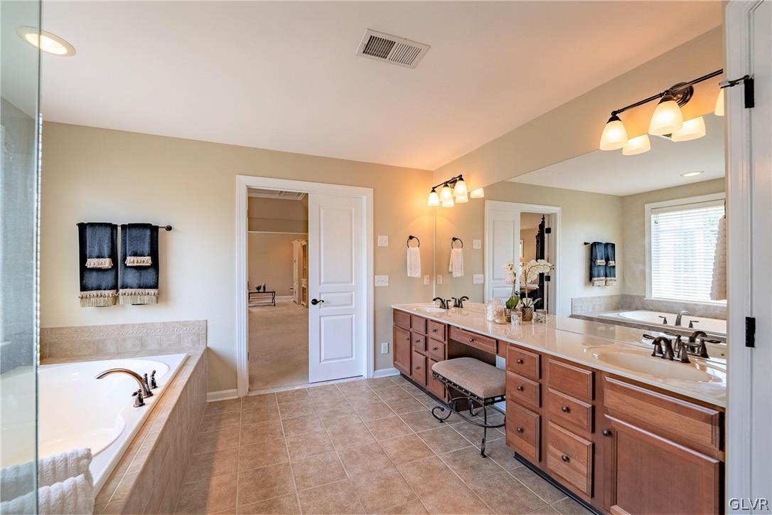 2296 Eldemere Circle Lower Macungie Township, PA 18062 - Photo 26 of 50 a spacious bathroom with a tub double sink window and mirror