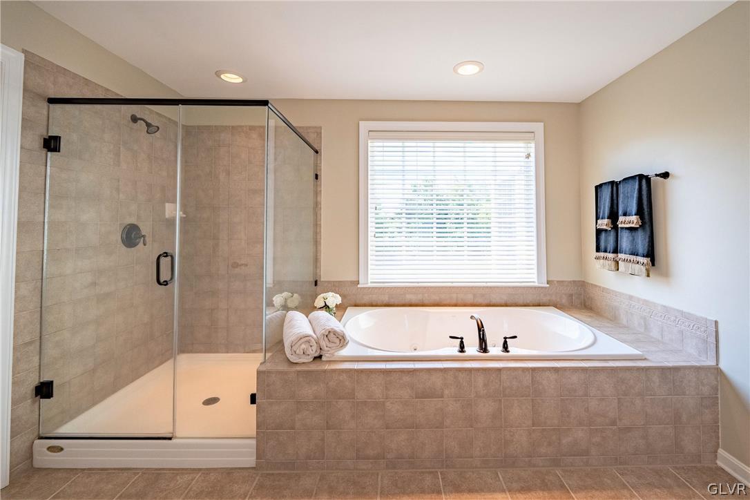 2296 Eldemere Circle Lower Macungie Township, PA 18062 - Photo 27 of 50 a bathroom with a bathtub and a shower