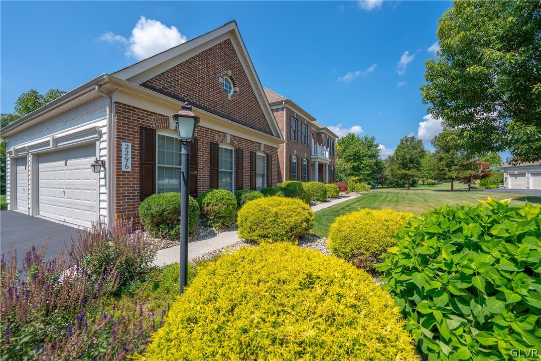 2296 Eldemere Circle Lower Macungie Township, PA 18062 - Photo 3 of 50 a view of yellow house with swimming pool and garden