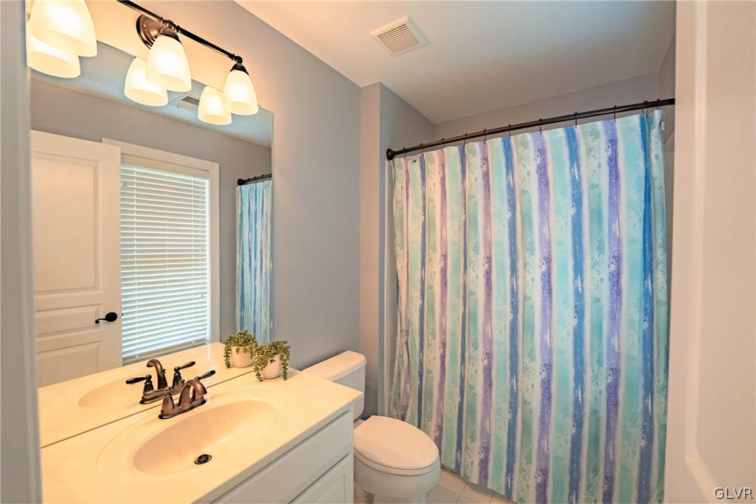 2296 Eldemere Circle Lower Macungie Township, PA 18062 - Photo 31 of 50 a bathroom with a sink a toilet and mirror