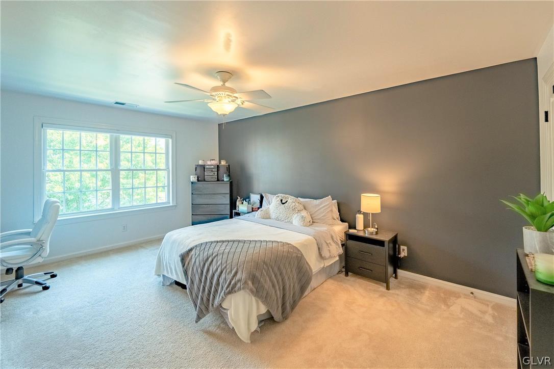 2296 Eldemere Circle Lower Macungie Township, PA 18062 - Photo 32 of 50 a bedroom with a bed and a chandelier