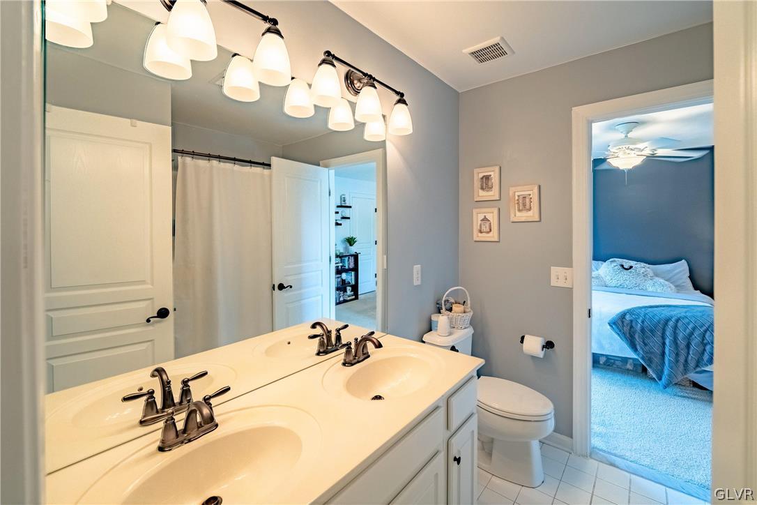 2296 Eldemere Circle Lower Macungie Township, PA 18062 - Photo 33 of 50 a bathroom with a sink a toilet and a mirror