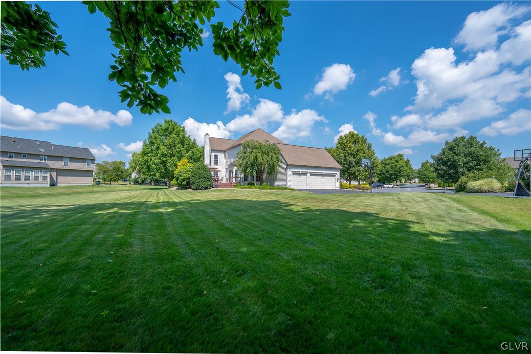2296 Eldemere Circle Lower Macungie Township, PA 18062 - Photo 46 of 50 a view of a garden with a house in the background