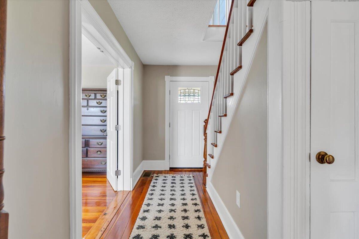 3861 Wheatland Road Bedford, VA 24523 - Photo 13 of 99 a view of hallway with wooden floor and stairs